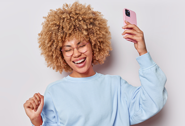 Lady smiling holding a phone